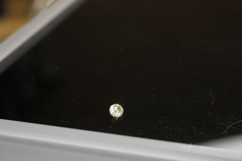An unmounted round brilliant cut diamond, weighing 1.02ct, with an estimated colour and clarity of S/T/U? and I3.